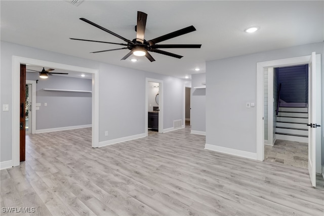 unfurnished living room with ceiling fan and light wood-type flooring