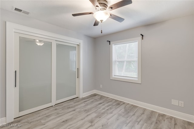 unfurnished room featuring ceiling fan and light hardwood / wood-style flooring