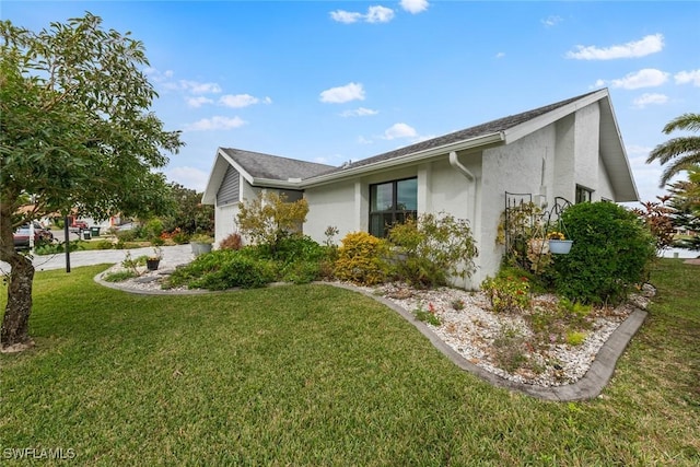 view of side of home featuring a yard