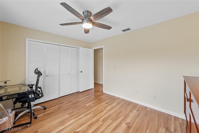 home office featuring light hardwood / wood-style floors and ceiling fan