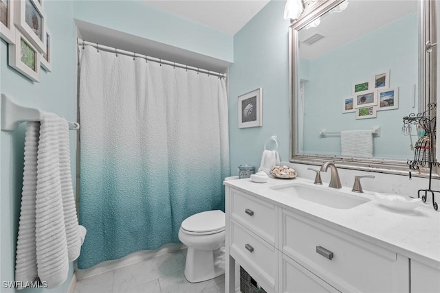 bathroom with vanity, tile patterned flooring, and toilet