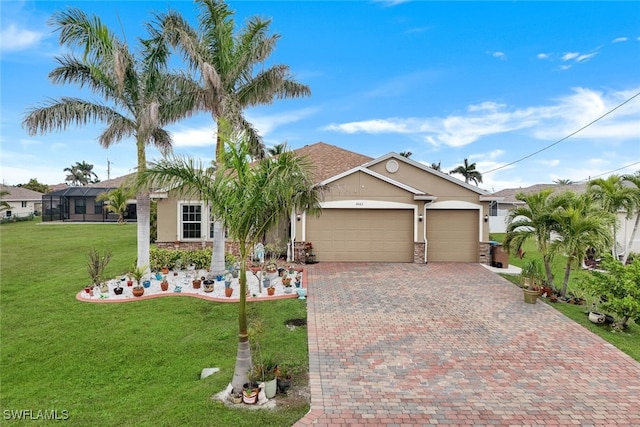 view of front of home with glass enclosure, a front yard, and a garage