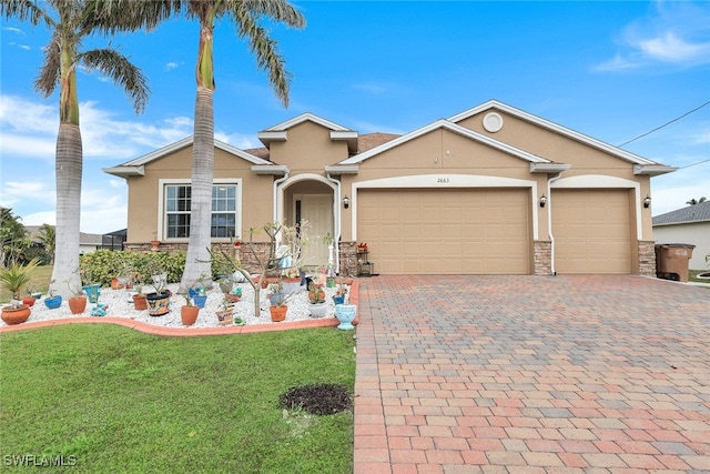 view of front of house with a garage and a front lawn