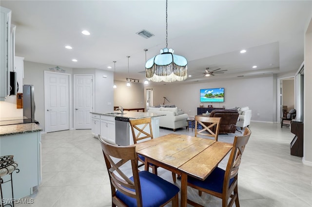 dining room with sink and ceiling fan