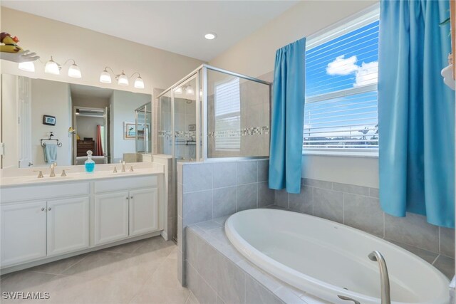 bathroom featuring vanity, shower with separate bathtub, and tile patterned flooring