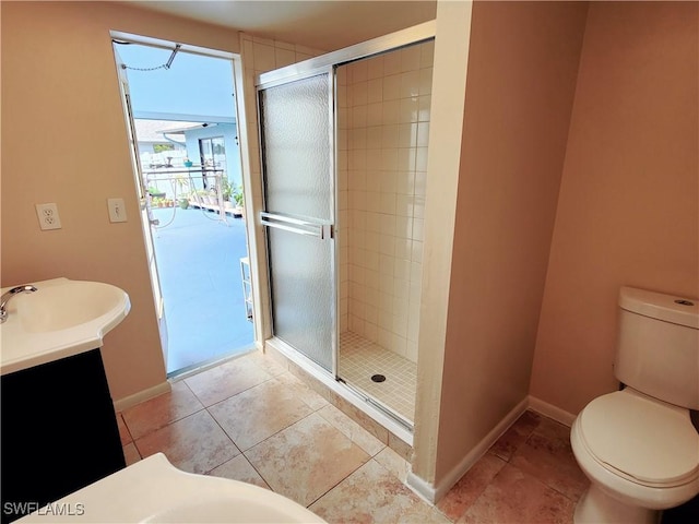 bathroom with an enclosed shower, vanity, and toilet