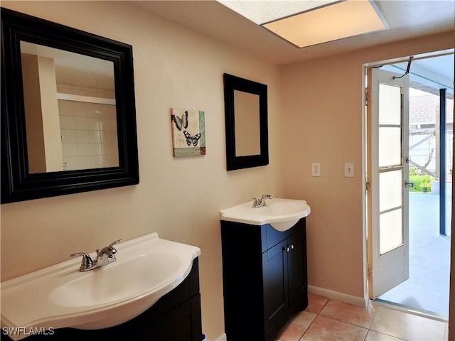 bathroom with vanity, tile patterned floors, and a shower