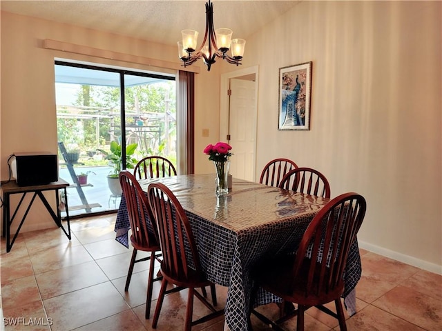 tiled dining room featuring an inviting chandelier