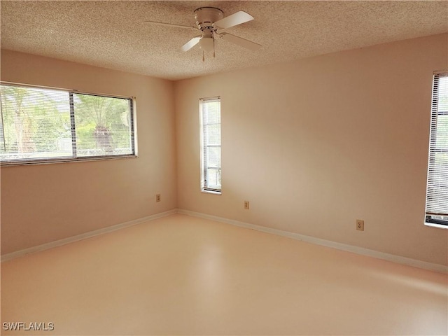 empty room featuring ceiling fan and a textured ceiling