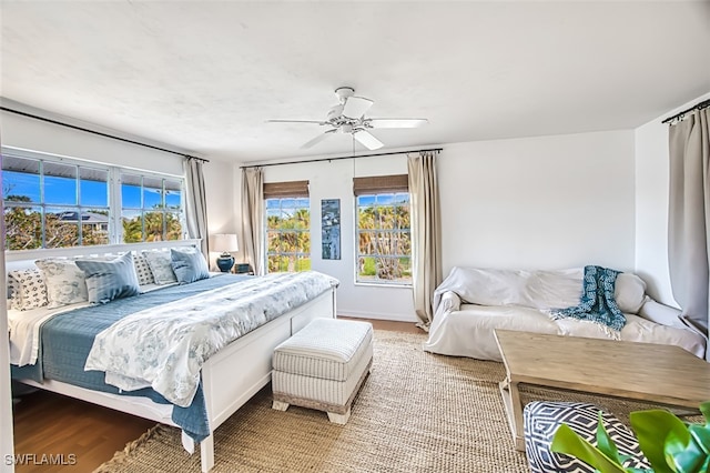 bedroom with ceiling fan and hardwood / wood-style flooring