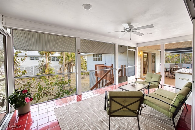 sunroom / solarium featuring ceiling fan