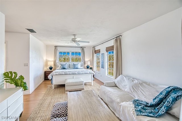 bedroom with ceiling fan and light hardwood / wood-style flooring