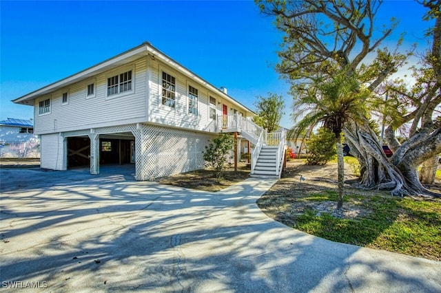 view of side of home with covered porch and a carport