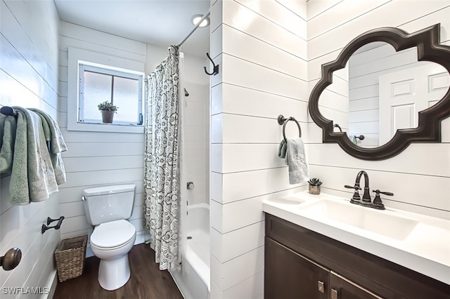 full bathroom with hardwood / wood-style floors, vanity, wooden walls, toilet, and shower / bath combo