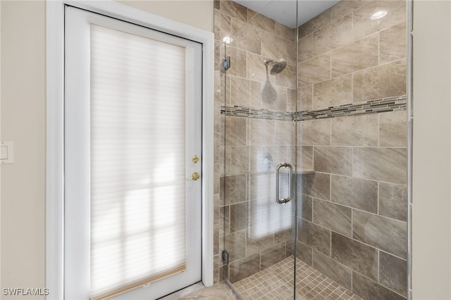 bathroom with a shower with door