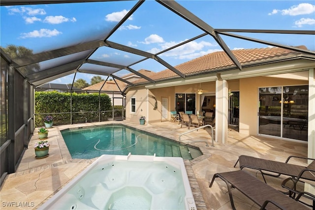 view of pool featuring an in ground hot tub, a lanai, ceiling fan, and a patio area