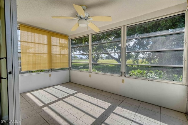 unfurnished sunroom featuring ceiling fan