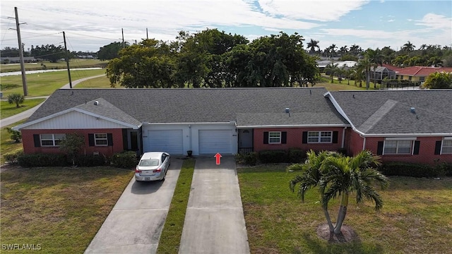 ranch-style home featuring a garage and a front yard