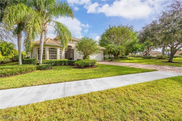 mediterranean / spanish-style house featuring a front lawn