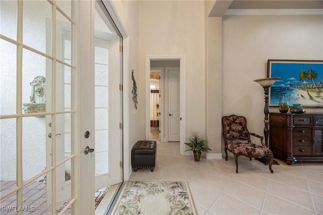 living area featuring light tile patterned floors and french doors