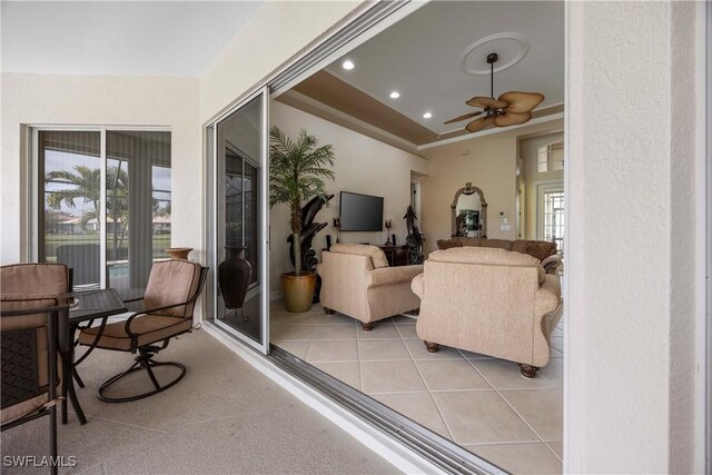 tiled living room with ceiling fan