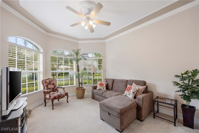 carpeted living room featuring crown molding and ceiling fan