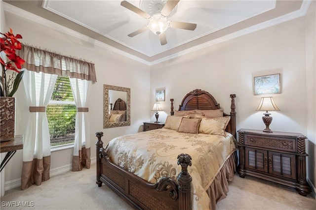 carpeted bedroom with ornamental molding and ceiling fan