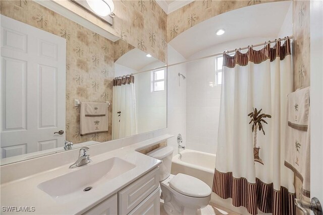 full bathroom featuring vanity, shower / bath combination with curtain, and toilet