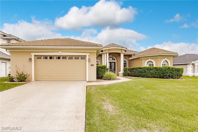 mediterranean / spanish-style home with a garage and a front yard