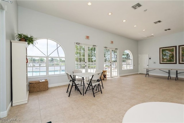 dining area featuring french doors and light tile patterned flooring