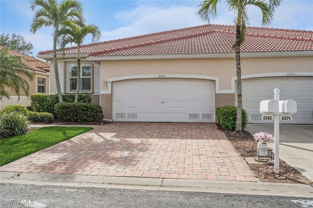 mediterranean / spanish-style home with a garage