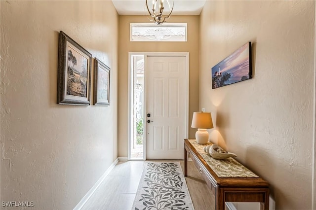 foyer entrance featuring an inviting chandelier and light tile patterned floors