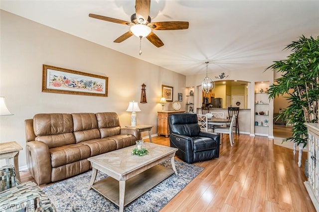 living room featuring light hardwood / wood-style flooring and ceiling fan