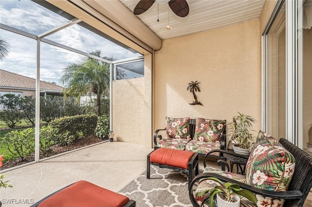 sunroom with ceiling fan and wooden ceiling