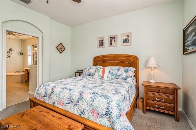 bedroom with light carpet and ensuite bath