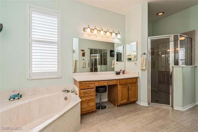 bathroom featuring vanity and separate shower and tub