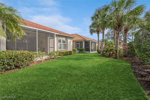 view of yard with a sunroom