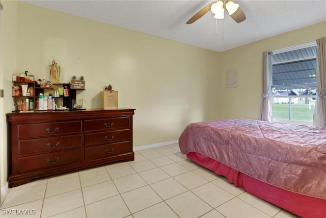 bedroom with ceiling fan and light tile patterned floors