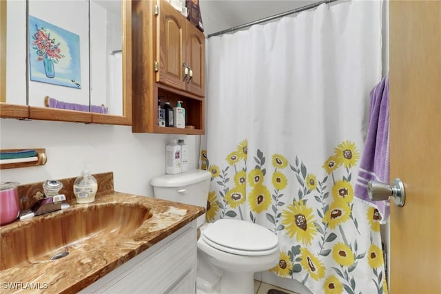 bathroom featuring toilet, vanity, and walk in shower