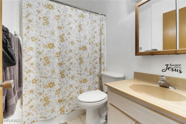 bathroom with toilet, tile patterned floors, and vanity