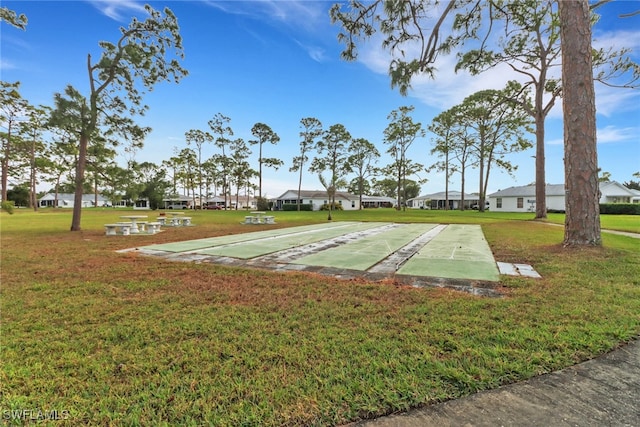 view of home's community featuring a lawn