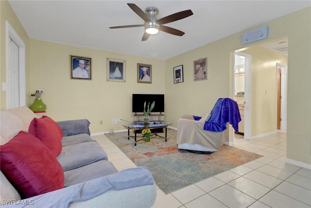 living room with ceiling fan and light tile patterned flooring