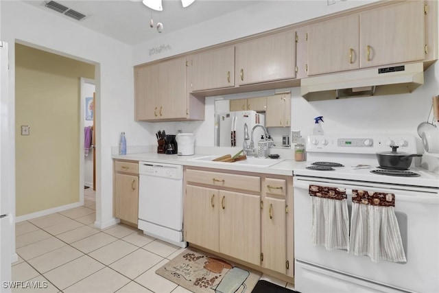 kitchen featuring light brown cabinetry, light tile patterned floors, sink, and white appliances