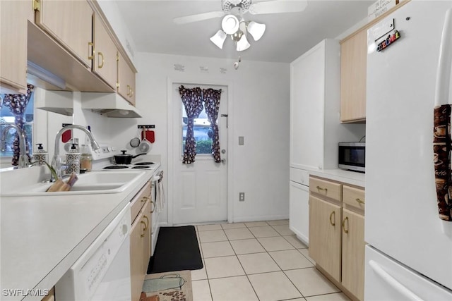 kitchen with light tile patterned floors, ceiling fan, light brown cabinets, white appliances, and sink