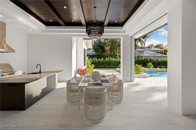 view of patio with area for grilling, a wet bar, and exterior kitchen