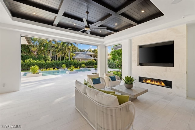 view of patio featuring an outdoor living space with a fireplace and ceiling fan