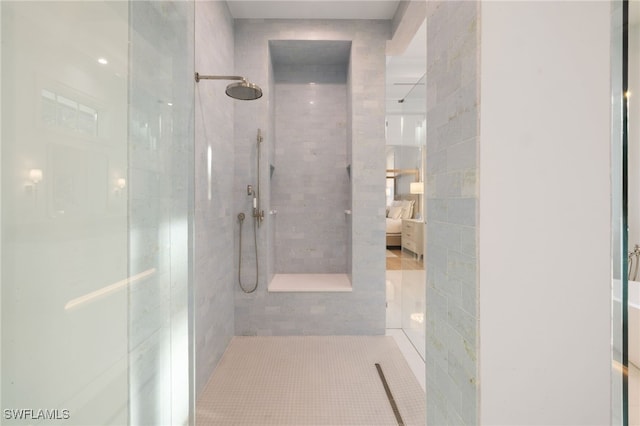 bathroom featuring tile patterned floors and tiled shower