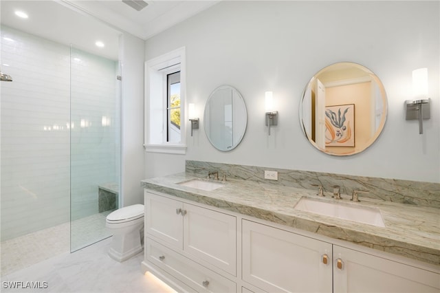 bathroom featuring vanity, toilet, and tiled shower