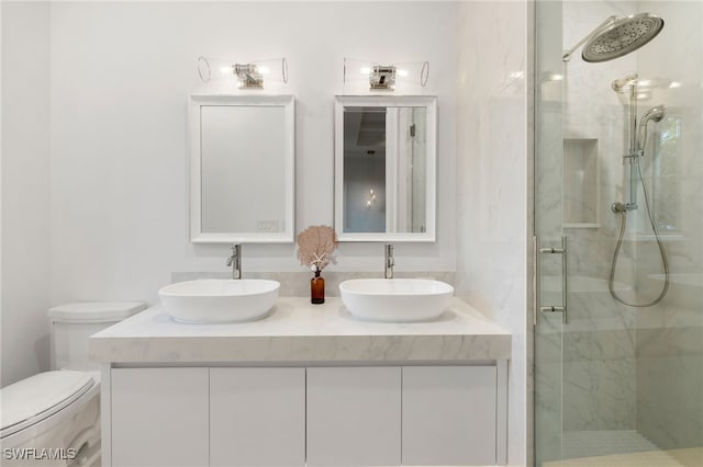 bathroom featuring vanity, an enclosed shower, and toilet