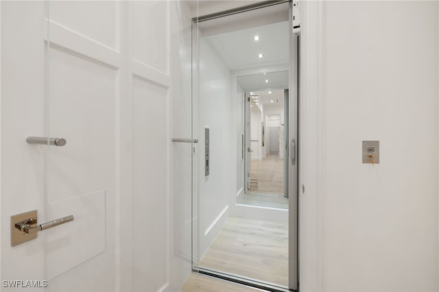 bathroom with hardwood / wood-style floors